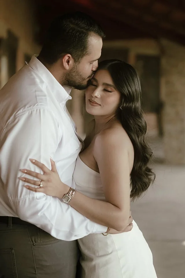 Yaritzy y Christian abrazados, él besando su sien